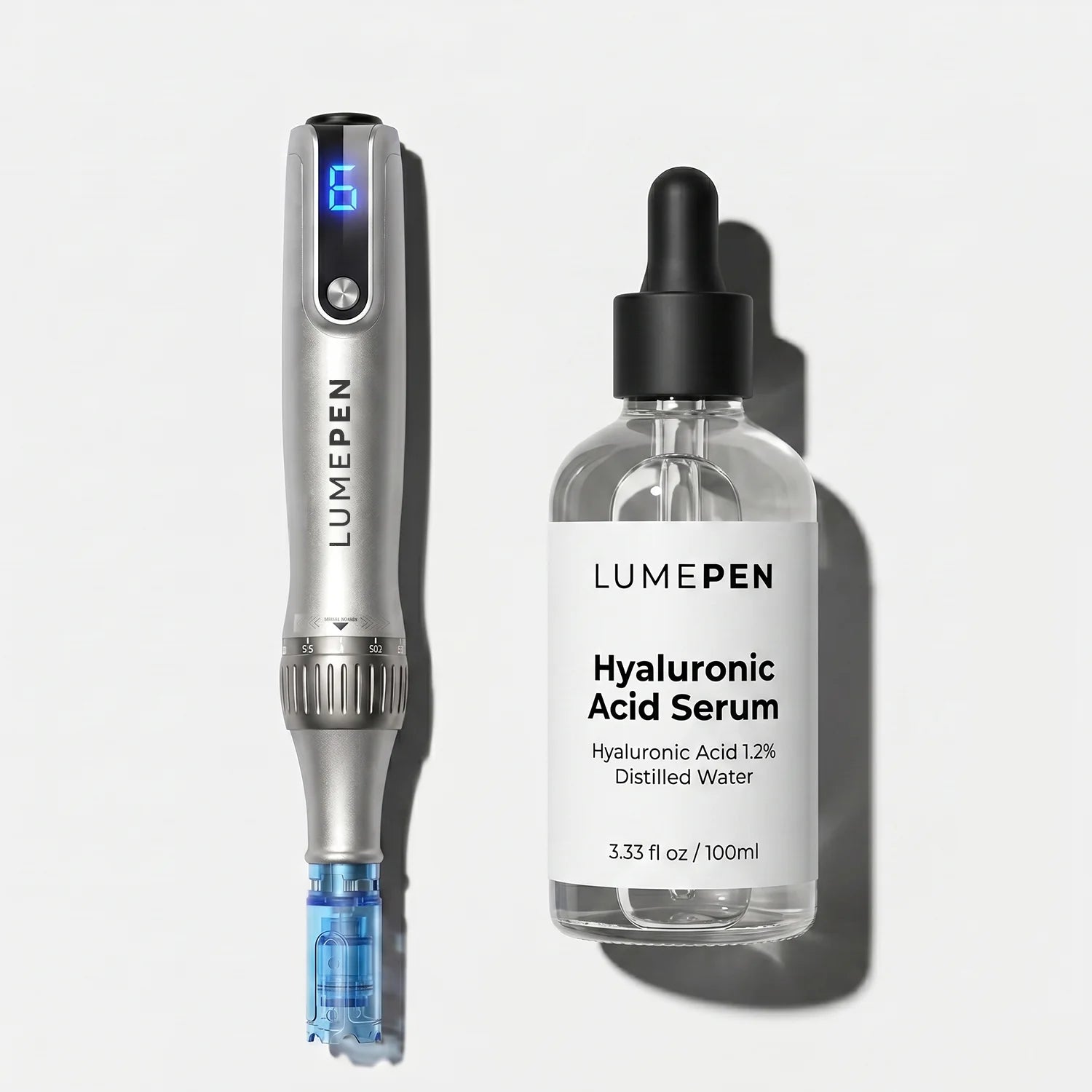 Premium product flat lay of the silver LUMEPEN PRO at-home microneedling pen alongside a clear glass dropper bottle of LUMEPEN Hyaluronic Acid Serum on a sleek light grey background.